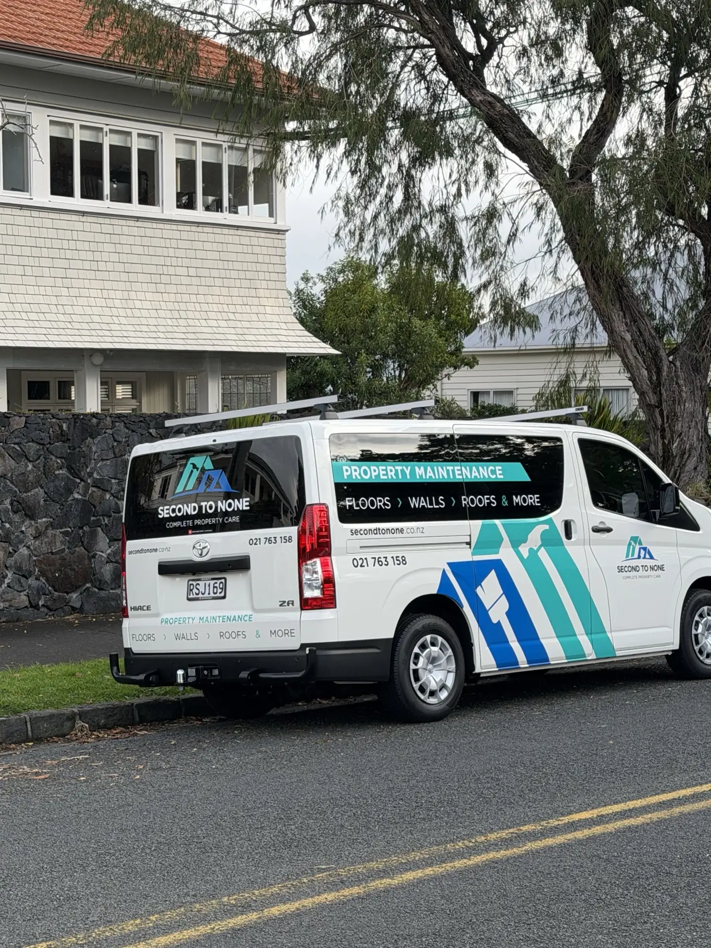 Signwritten Second to None van parked outside an Auckland weatherboard house