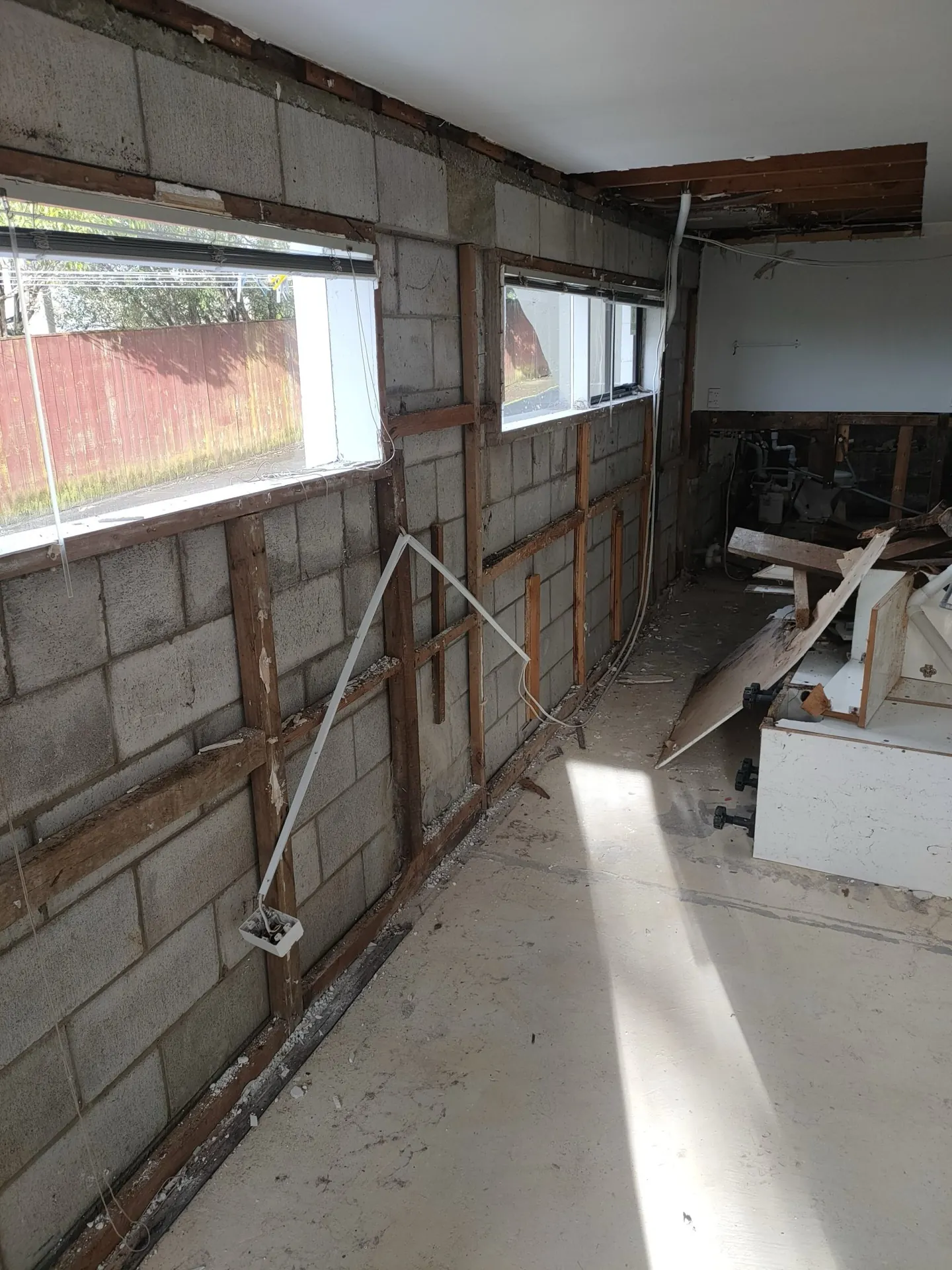 Interior strip-out exposing a concrete block wall, renovation in progress